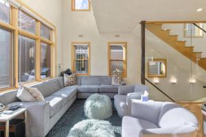 a living room with a couch and a staircase at West Pacific Ave 320 ~ Pacifico in Telluride +26 photos