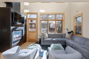 a living room with a couch and a tv at West Pacific Ave 320 ~ Pacifico in Telluride