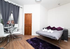 a white living room with a couch and a table at Cosy Apartment by Klass Living Bellshill in Bellshill