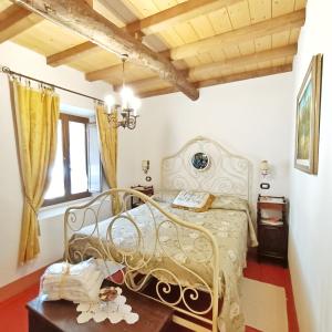 a bedroom with a metal bed in a room at Appartamento Maria Vittoria - Morciano di Romagna in Morciano di Romagna