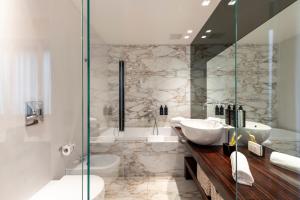 a bathroom with two sinks and a shower at Milan Royal Suites - Centro Brera in Milan