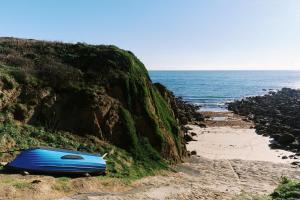 een blauwe boot aan de kant van een strand bij Corner Cottage in Penzance