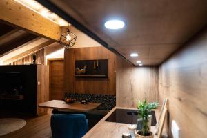 a dining room with a wooden table and blue chairs at Haus Gschösser in Reith im Alpbachtal