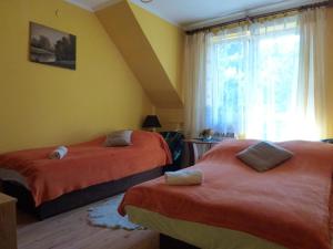 Ένα ή περισσότερα κρεβάτια σε δωμάτιο στο Pokoje Gościnne Vida