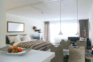 a bedroom with a bed and a bowl of fruit on a table at La Suite Swiss Alps in Davos