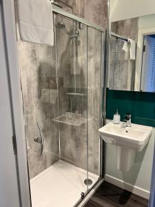 a bathroom with a shower and a sink at Killorn Guest House in Oban