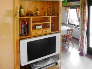 a television in a wooden cabinet in a living room at Holiday Home Tennenbronn-1 by Interhome in Tennenbronn
