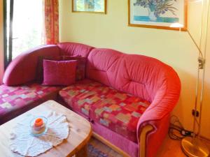 a living room with a pink couch and a coffee table at Holiday Home Tennenbronn-1 by Interhome in Tennenbronn