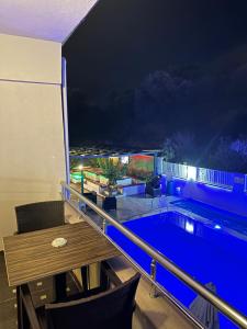 a balcony with a swimming pool at night at Street61 Apart Hotel in Sarigerme
