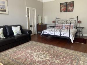 a living room with a bed and a couch at Kingston Farm in Bathurst