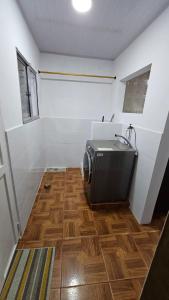 a bathroom with a sink and a wooden floor at Casa familiar barranco in Barranquilla