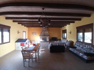 a living room with a table and chairs and a couch at Villa Nieves Bonillo in Villarrobledo