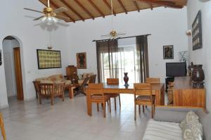 a dining room and living room with a table and chairs at Appartement à Saly in Saly Portudal