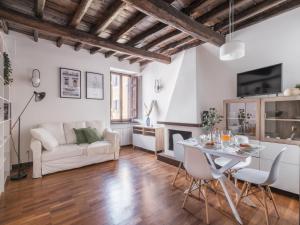 a living room with a table and a couch at The Best Rent - Elegant apartment in Trastevere in Rome