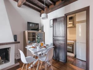 a kitchen with a table and chairs and a fireplace at The Best Rent - Elegant apartment in Trastevere in Rome