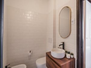 a bathroom with a sink and a toilet and a mirror at The Best Rent - Elegant apartment in Trastevere in Rome +9 photos