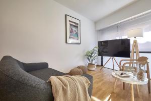 a living room with a couch and a table at BBarcelona Guinardó Flat in Barcelona