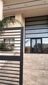 a house with black and white doors and windows at Appartement luxueux in Tunis