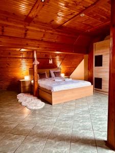 a bedroom with a bed in a wooden room at Apartman Tóth György in Bačka Topola