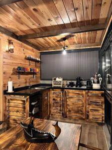 a kitchen with wooden cabinets and a black counter top at VİRA TAŞ KONAK in Trabzon