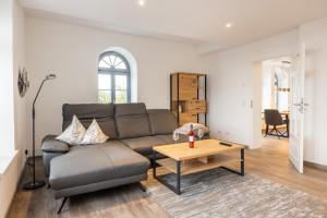 a living room with a couch and a table at Bed & Bahn Seesen in Seesen