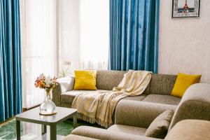 a living room with a couch and a table at Ekaterine's Apartments in Batumi