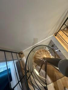 a spiral staircase in a building with a glass railing at charmant 2 pièces sur deux niveaux in Paris