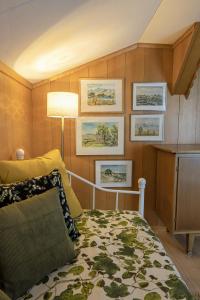 a bedroom with a bed and pictures on the wall at Capanna in Wildhaus