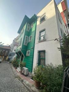 a green and white building on the side of a street at Sophia Studio Apart Hotel in Istanbul