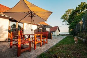 a patio with a table and chairs with an umbrella at Apartamenty - Grądzkie 19 in Grądzkie +28 photos