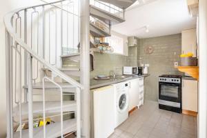 a kitchen with a white staircase in a room at Gorgeous 1 bedroom residential home In Sudbury. in Sudbury