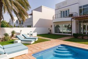 a villa with a swimming pool and a house at Private 5 Bed Villa / Next to Lagoon in Seeb