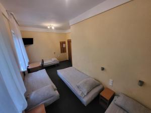 a hotel room with two beds and a tv at Hotel Parkowy in Malbork