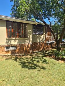 a house with a tree in front of it at @336 Bourke in Pretoria