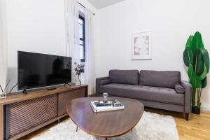 a living room with a couch and a coffee table at Apartment 283: Columbus Circle in New York