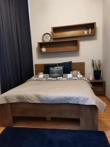 a bedroom with a large bed with a blue rug at Apartament na Rynku w Gnieźnie in Gniezno