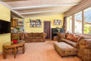 a large living room with couches and a table at Chalet Sunshine Argentiere Chamonix in Chamonix