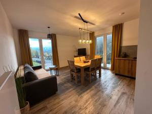a living room with a table and a dining room at Apartmán Pod sjezdovkami in Dolní Morava