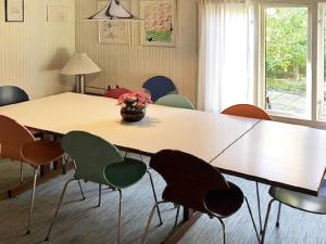 a conference room with a large wooden table and chairs at 8 person holiday home in Holb k in Holbæk