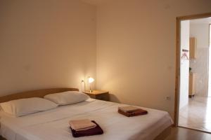 a bedroom with a bed with two towels on it at House Baglija in Lumbarda