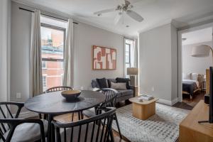 a living room with a table and chairs and a couch at East Village 2br w wd nr groceries NYC-1261 in New York