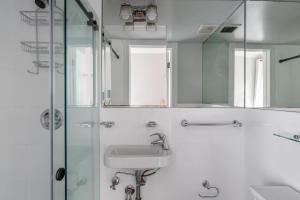 a bathroom with a sink and a shower with a mirror at East Village 2br w wd nr groceries NYC-1261 in New York