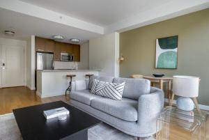 a living room with a couch and a table at Back Bay 1br w gym wd close to garden BOS-942 in Boston