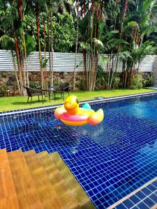 a pool with a rubber duck in a raft in the water at Sanook Villas -Geng Mak Nai Harn in Rawai Beach