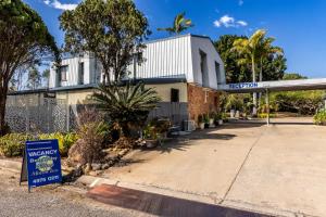 a gas station with a sign in front of it at Benaraby Hilltop MotorInn in Benaraby