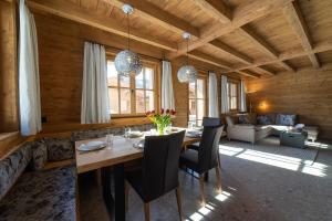 a dining room with a table and chairs in a room at Chalet Zuestoll in Wildhaus