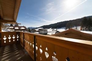 a balcony with a view of a snow covered mountain at Chalet Zuestoll in Wildhaus