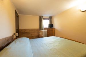 Una cama o camas en una habitación de Maison Godioz - Appartamento 2