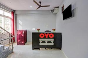 a living room with a tv and a table at The Urban Villa in Noida