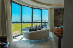 a living room with a couch and a large window at HOTEL HEKSAPOLİS in Tavşancıl